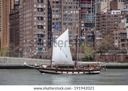 NEW YORK - APRIL 27: boat in the East River on April 27, 2014 in New York. The East River is a tidal strait that connects Upper New York Bay on its south end to Long Island Sound on its north end.