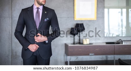 Man in custom tailored business suit posing indoors