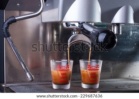 Espresso coffee machine, Coffee is pouring in a glass of coffee machine.