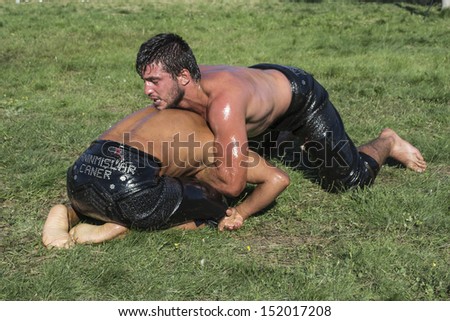 HILIA EVROS, GREECE - AUGUST 18:Unidentified wrestlers in the  Annual Oil Wrestling Event in HILIA-EVROS. Close up of oil wrestlers (Pehlivan) in a tight grip on August 18, 2013 in Hilia Evros, Greece