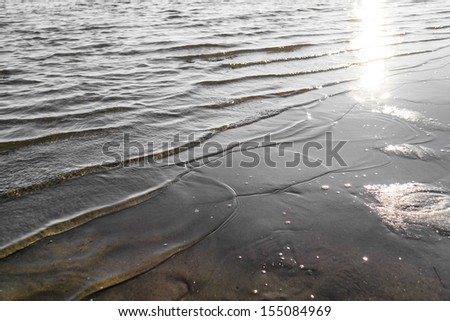 Bottom of the sea with ripples on water surface