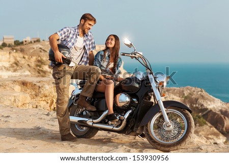 Two people and bike - fashion woman and man. Adventure and vacations concept