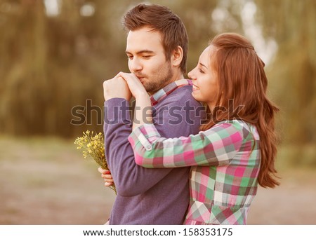 Guy Kisses The Girl\'S Hand In Park