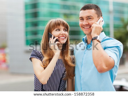 Young couple successful businessmen agree on the best deal. He was talking on the phone, it searches the internet for new business partners.
