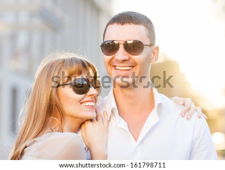 Couple kissing happiness fun. Interracial young couple embracing laughing on date.