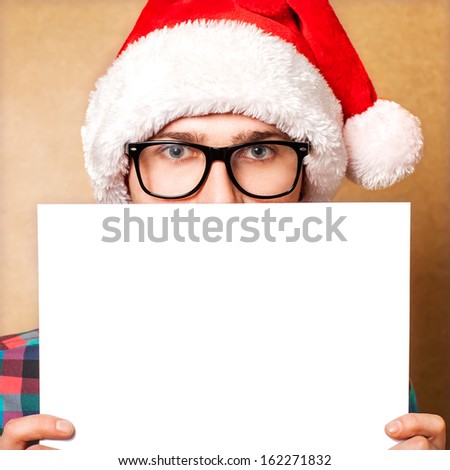 Santa Claus pointing in white blank sign with smile, isolated on background