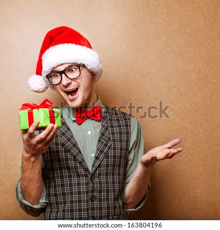 Guy holding a gift and emotionally happy Christmas