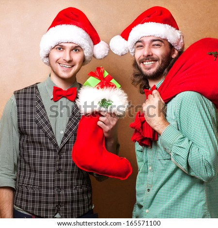 Two emotional Santa Claus dressed in clothes hipster with the bag of the presents