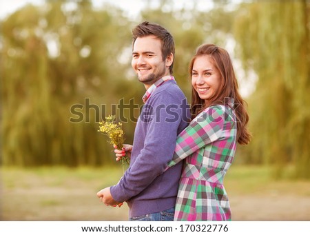 Young Couple In Love Walking In The Autumn Park Near The River.