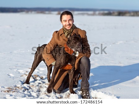 man playing with his dog outdoors