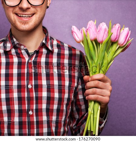 man clothing hipster holding a bouquet of flowers for Valentine\'s Day concept, mothers day, birthday.