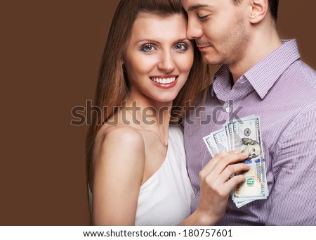 Fashion beautiful couple in love holding money