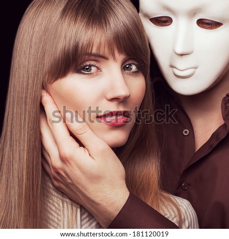 Fashion Happy Couple in Love holding a white mask face. Psychological concept. Duality look at relationships.