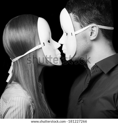 Fashion Happy Couple in Love holding with mask face. Psychological concept. Duality look at relationships.