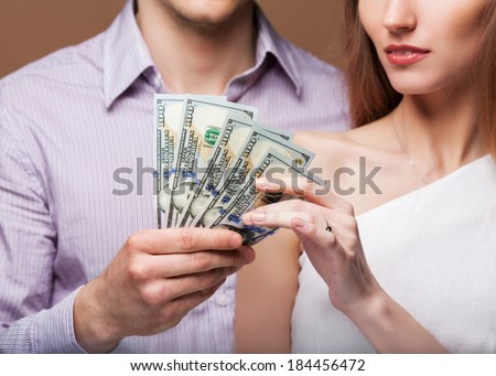 Loving couple are holding a large sum of money. Business concept. Family budget.