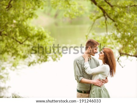 Couple in love walk near the riverr, smiling . Valentine\'s Day