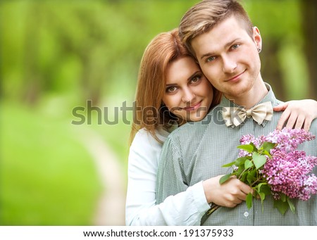 couple in love in blooming apple trees garden, smiling . Valentine\'s Day
