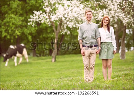 couple in love in blooming apple trees garden, smiling . Valentine\'s Day