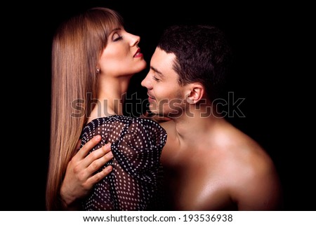 portrait of happy fashion couple hugging and kissing each othe