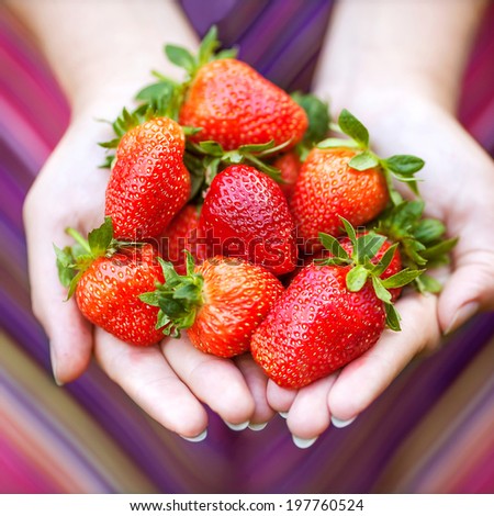 Strawberry in hands