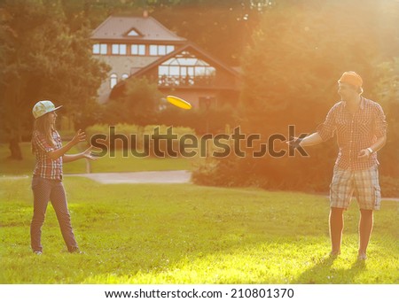A father and daughter spend a fun time at the park playing plate