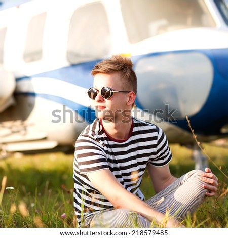 Hipster fashion man near helicopters at the airport