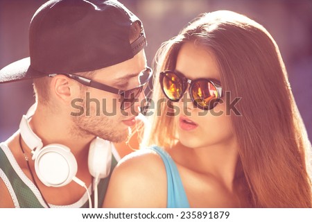 Close up portrait of happy smiling hipster couple in love. Wearing retro clothes and sunglasses. Fashion. Vogue.