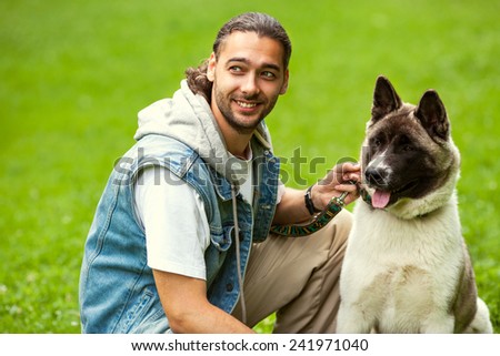 man with his dog breed Aki