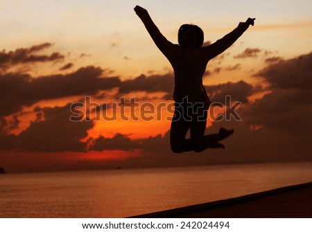silhouette girl jumping in sunset