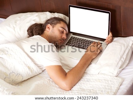 man freelancer lies a sleep in bed with a laptop, work is free earnings happy business