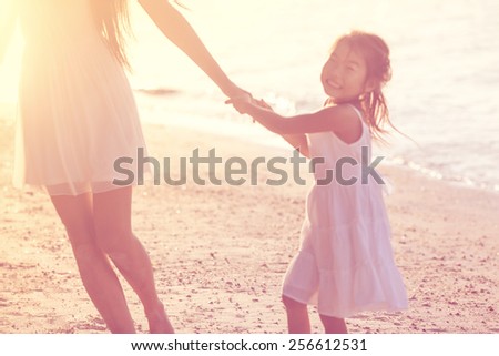 mother and daughter happy in love at sunset, blur - concept.