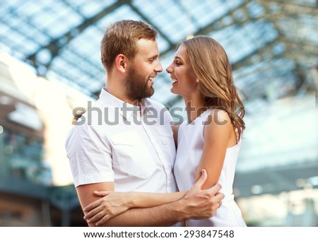 guy doing on the nature engagement girl, surprise, emotion, sunset couple in love hugging and laughing much looking at each other in white clothes, wedding concept