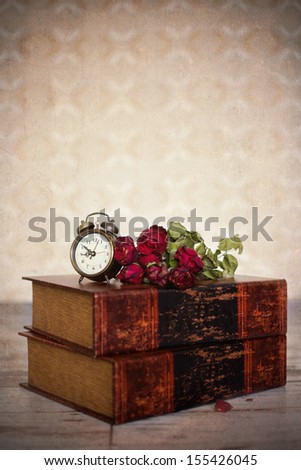 Books, roses and clock
