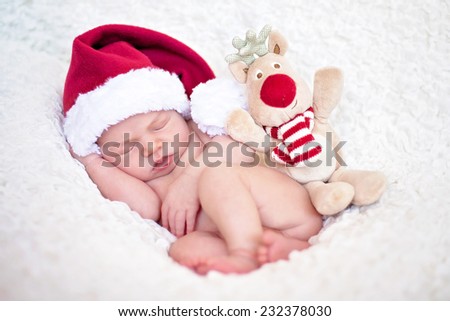 Adorable baby boy, sleeping with santa hat