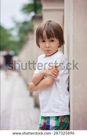 Portrait of a little angry boy, outdoors, boy expressing his emotions