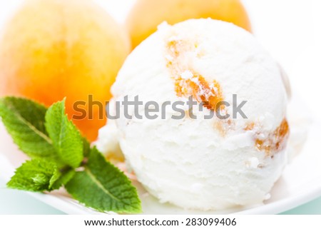 Yoghurt - apricot ice cream scoop with apricot and mint leafs