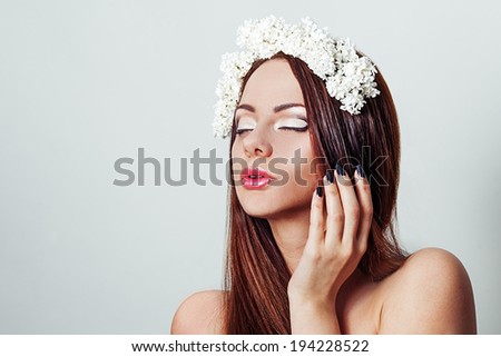 BEAUTY portrait of a girl with flowers in her hair. Brunette girl with the white  lilac flowers.