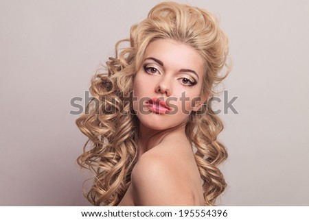 Beauty portrait of a beautiful blonde. Young girl with more voluminous hair. Professional makeup