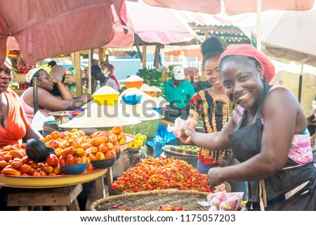 scene from a market with women selling food items like peppers and tomatoes
