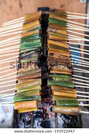 Thai dessert made by rice flour wrap with banana leaves on stove