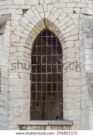 Broken window at the wall of the old church
