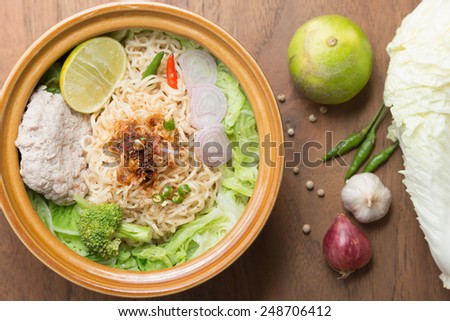 Healthy Eating Hot and spicy noodle with pork and vegetables on the wood background