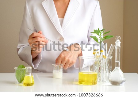 the scientist,dermatologist testing the organic natural cosmetic product in the laboratory.research and development beauty skincare .cream,serum.hand