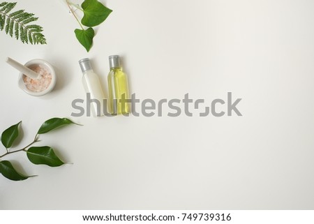 Cosmetic package containers with green leaves, pink salt,herbal . natural  organic beauty product concept mock up. Blank bottle for label own branding skincare. isolated white background.top view.
