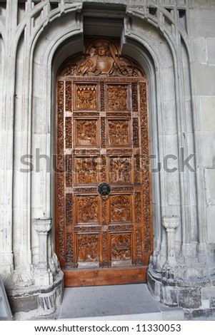 The entrance to the catholic cathedral in Constance, Germany. The finely carved doors are set in an ornate carved stone frame.