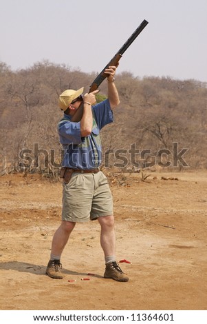 Shooting at clay pigeons with a shotgun in a typical Mpumalanga Bushveld setting.