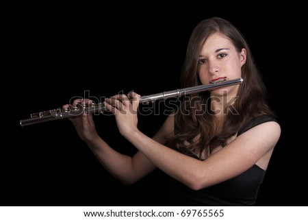 A young girl playing the flute - low key
