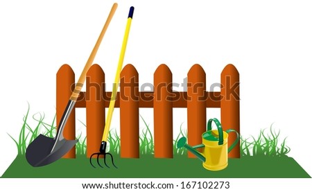 Simple brown fence in grass with garden tools