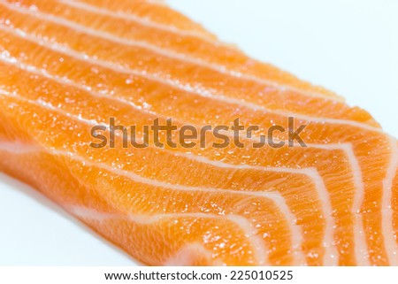 Close up of salmon slices on white background.