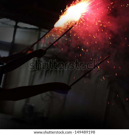 Holding exploding Fireworks with strong lights
